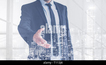 real estate business man  offering hand for handshake , city skyline double exposure Stock Photo