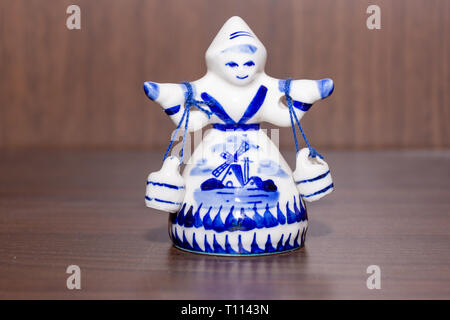 Delft Blue Figurine of girl carrying bells. Souvenier from Holland/Netherlands. Stock Photo