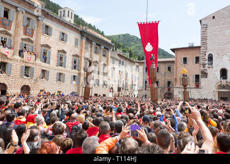 GUBBIO, ITALY - MAY 15 2016 - The Ceri start to race around the Piazza Grande as the crowd look on at the annual Festa dei Ceri. Stock Photo