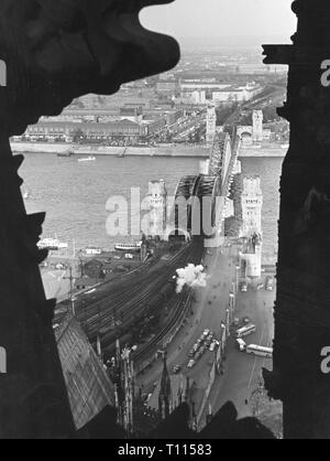 Germany, cities and communities, Cologne, bridges, Hohenzollernbruecke (Hohenzollern Bridge), topview from a tower of the cathedral, 1957 city, people, river, rivers, Rhine, railroad bridge, railway bridge, road bridge, destruction, destructions, demolitions, war damage, portal, portals, transport, transportation, railway, railroad, railways, railroads, view to Deutz, Rhineland, North Rhine-Westphalia, Germany, Europe, 20th century, 1950s, bridges, bridge, topview, top view, topviews, top views, tower, towers, cathedral, cathedrals, historic, his, Additional-Rights-Clearance-Info-Not-Available
