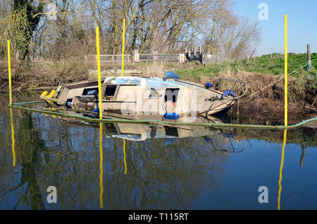 abandoned sunken boat  on river waveney geldeston norfolk england Stock Photo