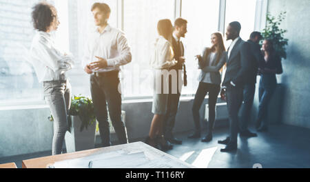 Business colleagues talking, having break in office Stock Photo