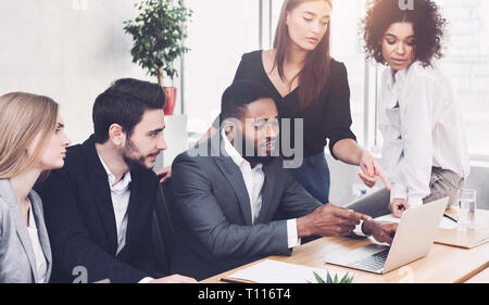 Business discussion. Colleagues analyzing data on laptop Stock Photo