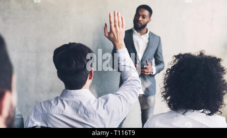 Businessman raising his hand, having question, crop Stock Photo