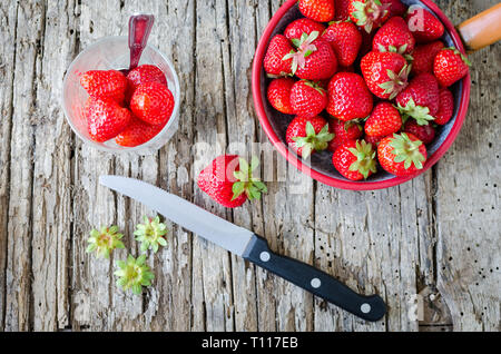 Ripe strawberries on a cutting board with a knife. Stock Photo