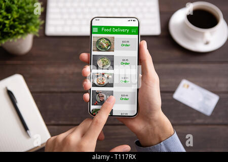 Hand touching phone screen for choosing food Stock Photo