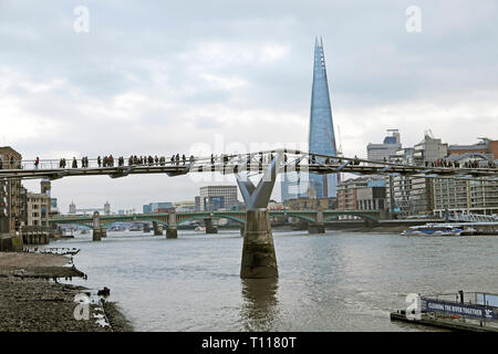 A view of the Shard building South Bank, London cityscape and people walking on the Millennium Bridge over the River Thames in winter UK KATHY DEWITT