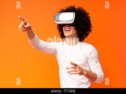 Cheerful man trying vr glasses at home Stock Photo