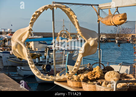 Shark jaw and other fishing products and souvenirs at the old Venetian harbor, City of Chania, Crete island, Greece Stock Photo
