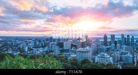 Beautiful sky and sunrise light over Montreal city in the morning time. Amazing view from Mont-Royal with colorful blue architecture. Stunning panoram Stock Photo