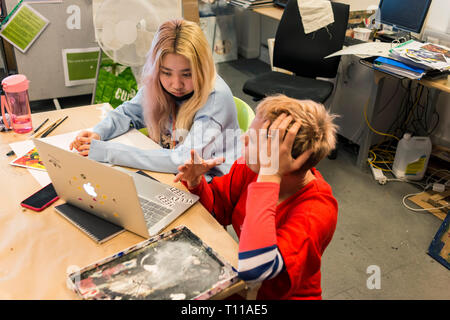 photos in an art lesson in the art class of a college with lots of students. Stock Photo