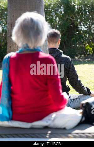Two people meditating at the meditation gardens in Encinitas California Stock Photo