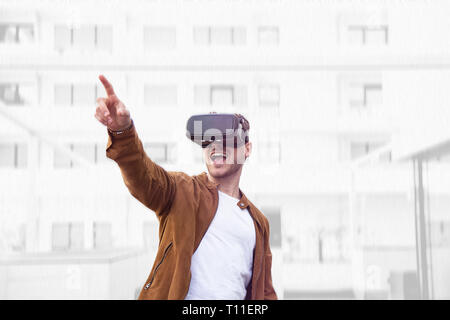 Cheerfully Young Adult Charming Man Using VR Virtual Reality Glasses with Draw Background Stock Photo