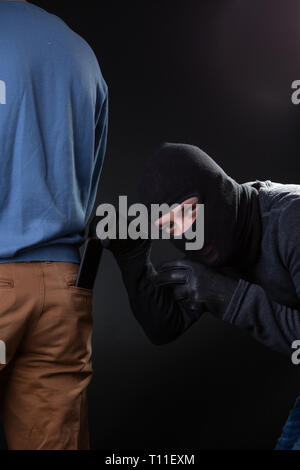 Thief steals man from wallet pocket Stock Photo