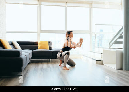Adult Woman Training Legs Doing In and Out Squat Stock Photo