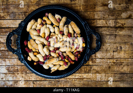 Roasted peanuts in a shell on a plate top view Stock Photo