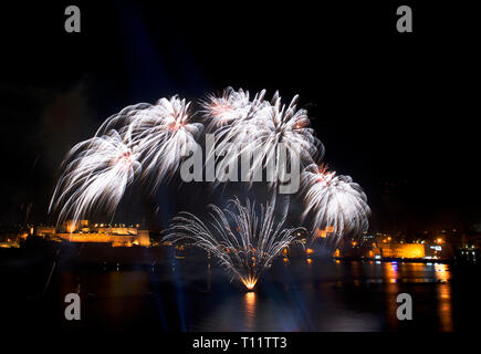 Fireworks show,colorful fireworks on the black sky background, fireworks explosion in the dark sky with city silouthe on bottom, fireworks in Malta Stock Photo