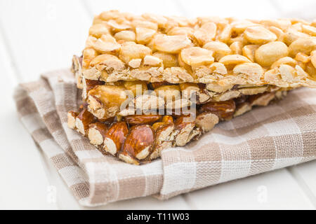 Sweet nut bars with honey on checkered napkin. Stock Photo