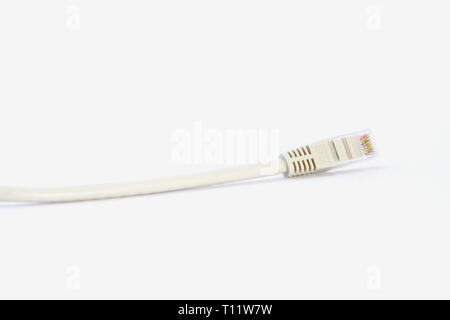 a short gray patchcable in front of a white background Stock Photo