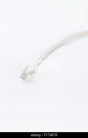 a short gray patchcable in front of a white background Stock Photo