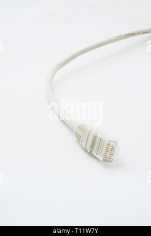 a short gray patchcable in front of a white background Stock Photo