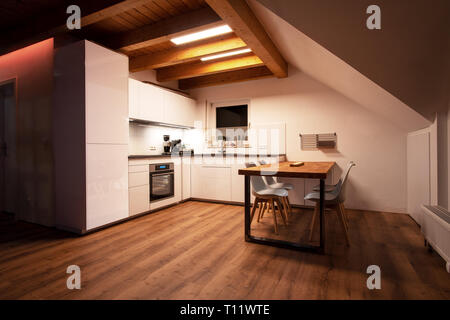 Stylish kitchen with with elegant shiny table and stove Stock Photo - Alamy