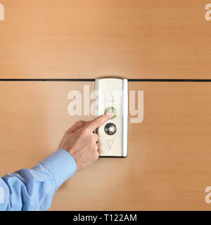 Clerk pressing the button and calling the elevator going up Stock Photo