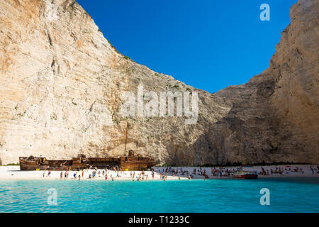 Greece, Zakynthos, Navagio. Famous shipwreck on a secluded beach with tourists. Stock Photo