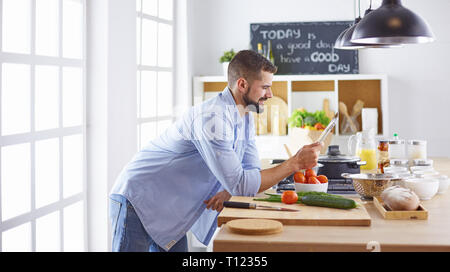 Smiling and confident chef standing in large kitchen Stock Photo