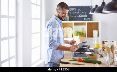 Smiling and confident chef standing in large kitchen Stock Photo