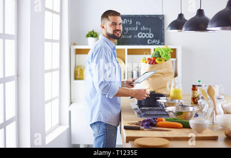 Smiling and confident chef standing in large kitchen Stock Photo