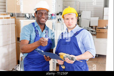 Professional male contractors discussing while determining scope of building work indoors Stock Photo