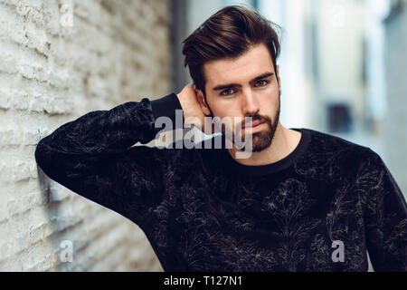 Young bearded man, model of fashion, in urban background wearing casual clothes. Stock Photo