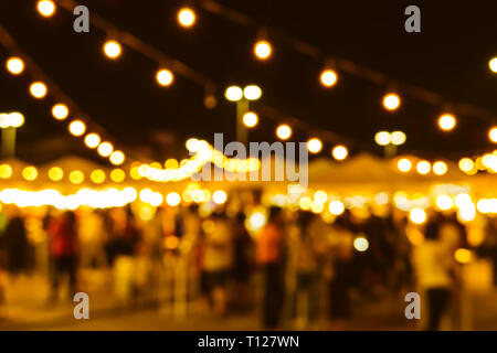 blur night festival tungsten warm light market outdoor for background. Stock Photo