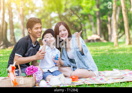 Asian family happy vacation with child kid father and mother play in the park. Stock Photo