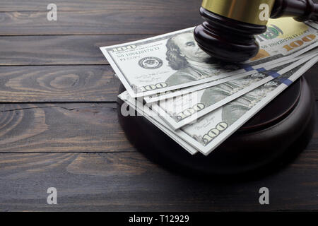 judge gavel and money on brown wooden table concept Stock Photo