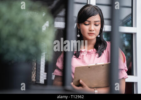 business woman with clipboard checking some stuff  Stock Photo