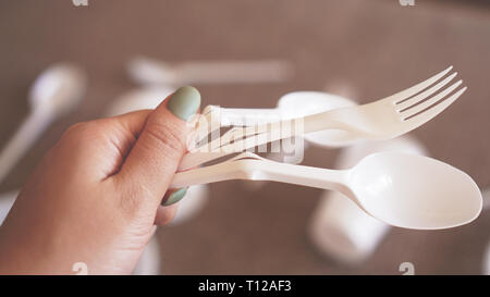 Hands break plastic dishes, people ban and stop using plastics garbage. Concept of Recycling plastic and ecology - blurred background Stock Photo