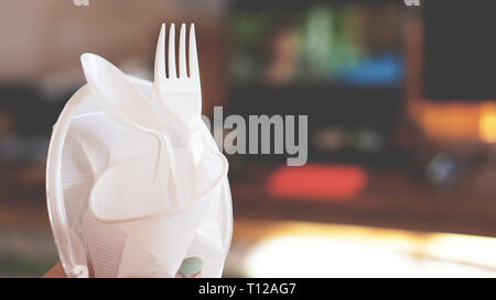Hands break plastic dishes, people ban and stop using plastics garbage. Concept of Recycling plastic and ecology - blurred background Stock Photo