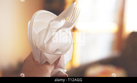 Hands break plastic dishes, people ban and stop using plastics garbage. Concept of Recycling plastic and ecology - blurred background Stock Photo