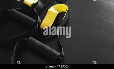 Black And Yellow Strap Functional Training Equipment On Grey