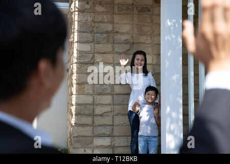 father waving goodbye to his family before going to work Stock Photo