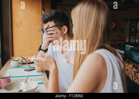 Quarrel between two young people in a coffee house, in a bar or restaurant. Stock Photo