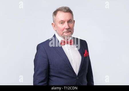 Senior man in blue suit looking confident Stock Photo