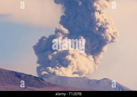 Sabancaya Volcano, column of smoke and ash as it erupts in July 2017. The Andes Mountains, Peru, South America. Stock Photo