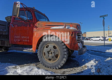WHITEHORSE, YUKON, CANADA, March 8, 2019 : Old truck as a decoration at the crossroad. Whitehorse is the capital and only city of Yukon, and the large Stock Photo