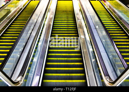 Yellow marked escalators in Budapest metro. Metro line 4 architecture. Stock Photo