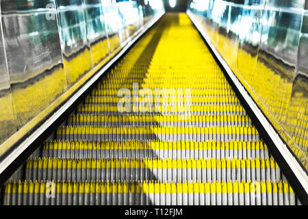 Yellow marked escalators in Budapest metro. Metro line 4 architecture. Stock Photo