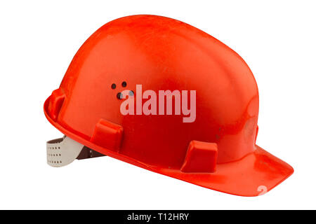 side view of used orange hard hat on white background with dirt and stains isolated on white background Stock Photo