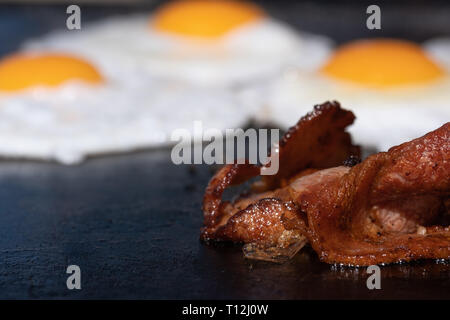 Closeup image of a cooking bacon on a barbecue at a school fundraiser on election day in Australia Stock Photo